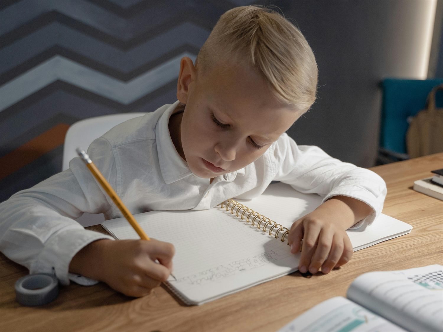 A child writing calmly in a notebook